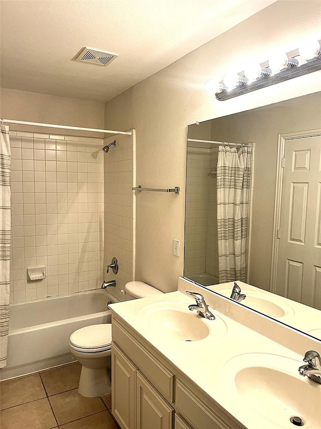 full bath featuring a sink, visible vents, shower / tub combo with curtain, and tile patterned flooring