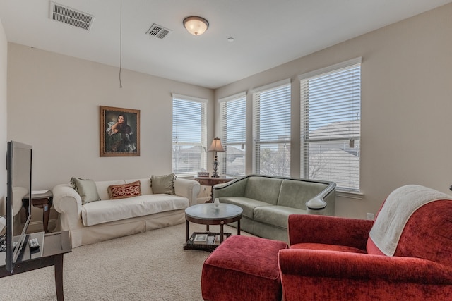 living room with visible vents and carpet floors