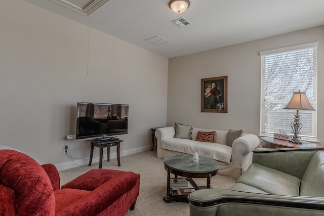 living area featuring attic access, baseboards, visible vents, and carpet floors