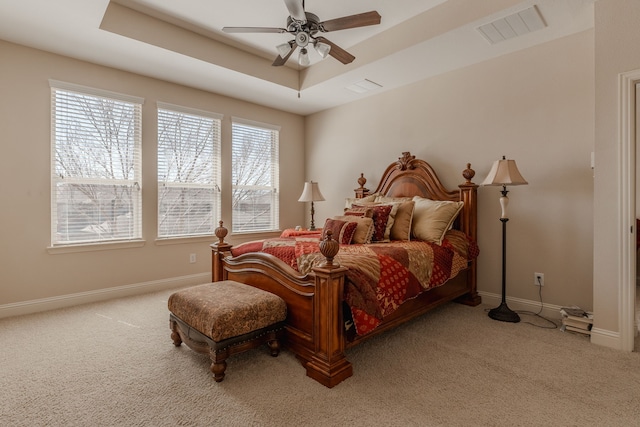 bedroom featuring visible vents, ceiling fan, baseboards, carpet floors, and a raised ceiling