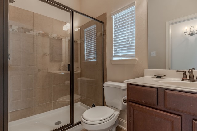 full bathroom with a shower stall, toilet, and vanity