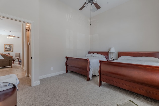 bedroom with ceiling fan, baseboards, carpet, and a towering ceiling