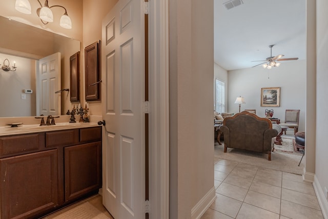 bathroom with visible vents, baseboards, tile patterned floors, vanity, and a ceiling fan