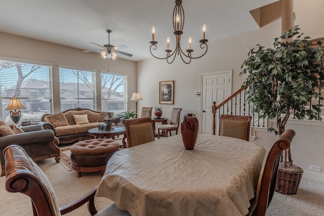 dining space with stairway, carpet flooring, and ceiling fan