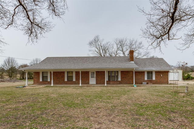 ranch-style home with a front yard and brick siding