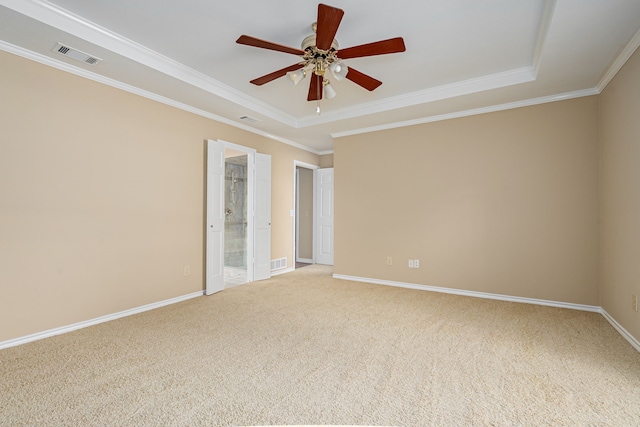 empty room with light carpet, baseboards, visible vents, and crown molding