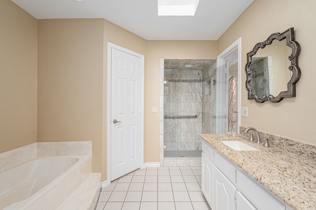 bathroom featuring a skylight, tile patterned floors, vanity, a shower stall, and a bath