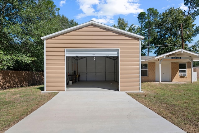 garage with driveway and fence