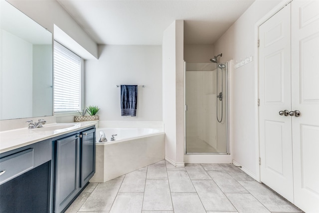 full bath featuring vanity, a garden tub, a shower stall, and tile patterned flooring