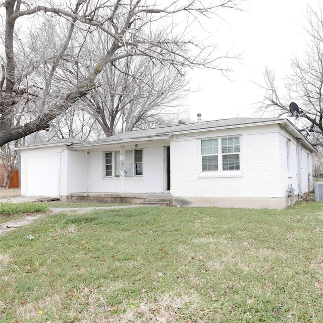 ranch-style house featuring a front yard, brick siding, and an attached garage