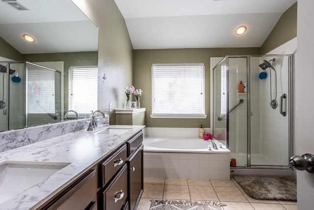 bathroom featuring lofted ceiling, a stall shower, and a sink