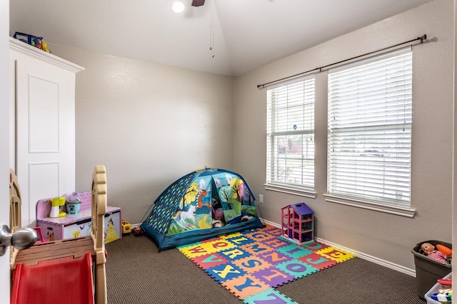 recreation room featuring carpet flooring, ceiling fan, and baseboards