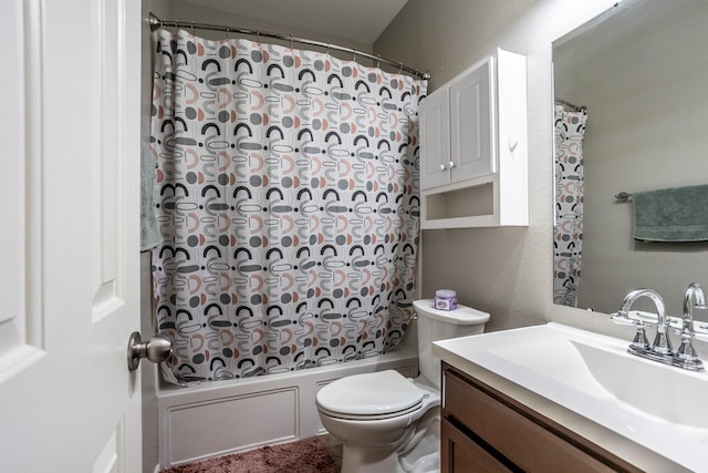 full bathroom featuring toilet, vanity, tub / shower combination, and a textured wall