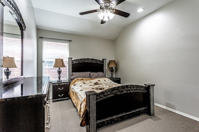 bedroom featuring lofted ceiling, a textured wall, carpet, and baseboards