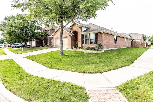 single story home with driveway, a garage, a front lawn, and brick siding