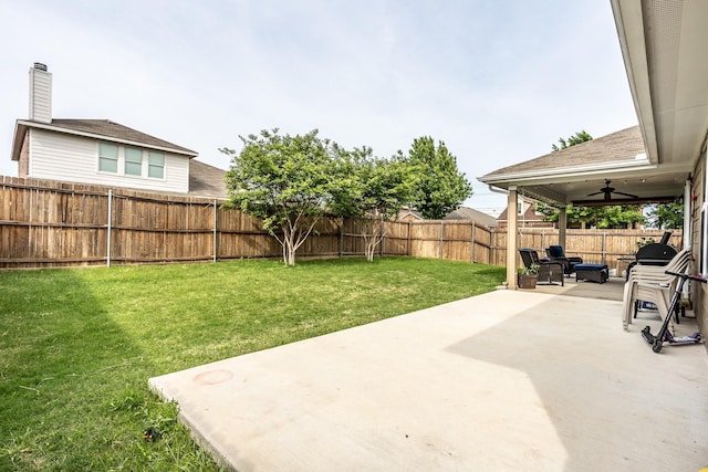 view of yard featuring ceiling fan, a fenced backyard, and a patio