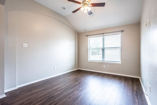 spare room with dark wood-style floors, lofted ceiling, baseboards, and a ceiling fan