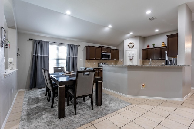 dining area with recessed lighting, visible vents, vaulted ceiling, and light tile patterned flooring