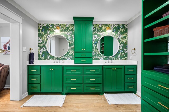 7811 Double Oaks Rd, Athens, TX 75752 - bathroom featuring wallpapered walls, double vanity, crown molding, wood finished floors, and baseboards