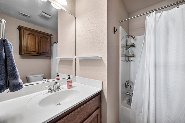 7811 Double Oaks Rd, Athens, TX 75752 - bathroom with vanity, toilet, shower / bathtub combination with curtain, and a textured wall