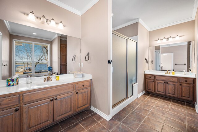7811 Double Oaks Rd, Athens, TX 75752 - bathroom with ornamental molding, a stall shower, tile patterned floors, two vanities, and baseboards