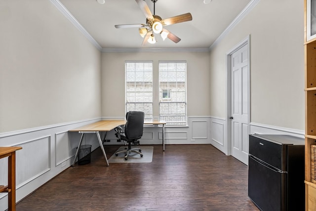 office with a wainscoted wall, dark wood finished floors, a ceiling fan, and crown molding