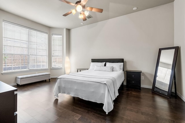 bedroom with visible vents, baseboards, ceiling fan, and wood finished floors