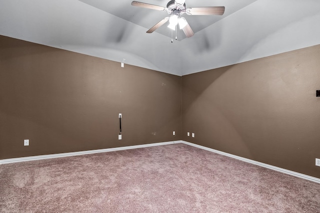 spare room with carpet floors, ceiling fan, baseboards, and vaulted ceiling