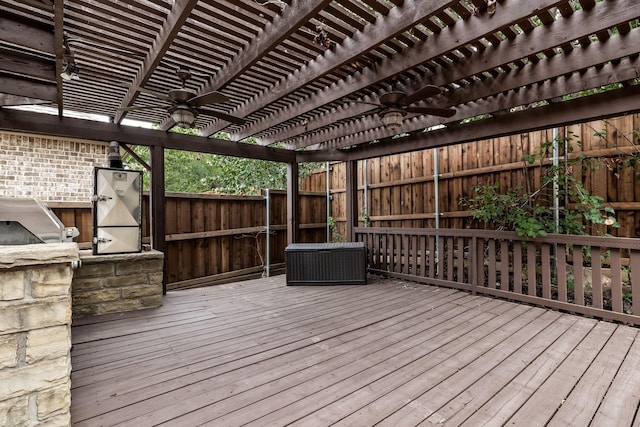 deck featuring fence, a ceiling fan, and a pergola