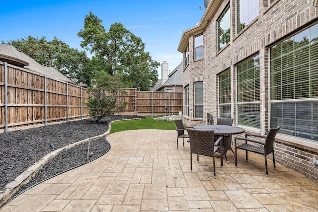 view of patio featuring a fenced backyard and outdoor dining area