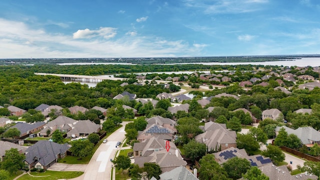 drone / aerial view featuring a water view and a residential view