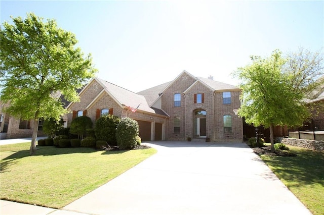 traditional-style house with a garage, concrete driveway, brick siding, and a front lawn