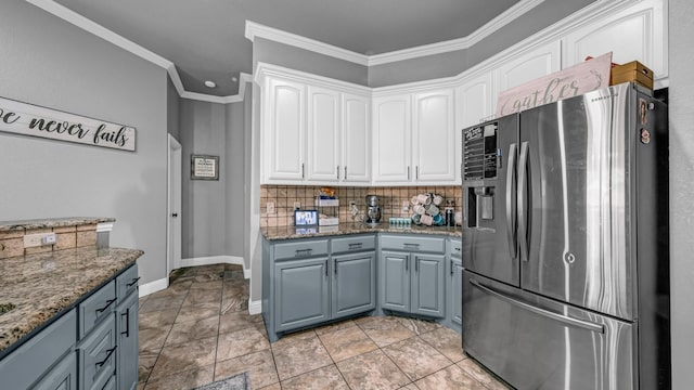 kitchen with stone countertops, white cabinets, decorative backsplash, crown molding, and stainless steel refrigerator with ice dispenser