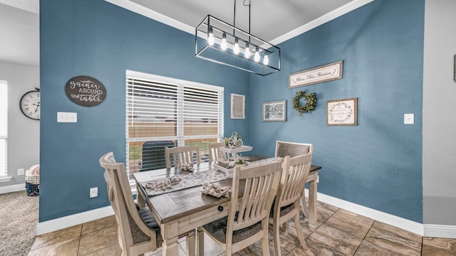 tiled dining room featuring baseboards and ornamental molding