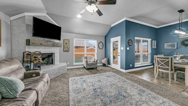 carpeted living room with vaulted ceiling, a healthy amount of sunlight, a fireplace, and baseboards