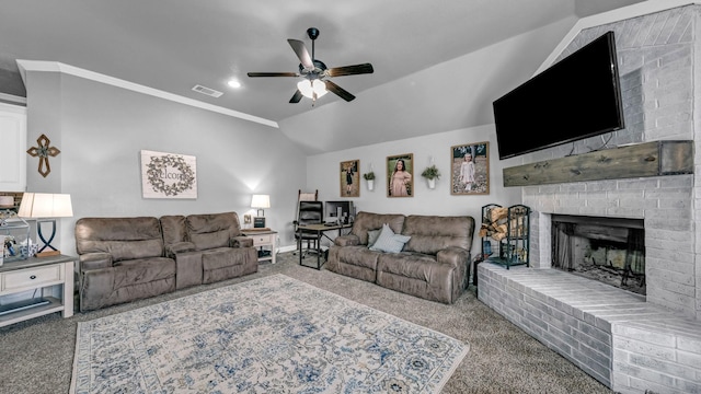 living area with visible vents, ceiling fan, carpet, vaulted ceiling, and a fireplace