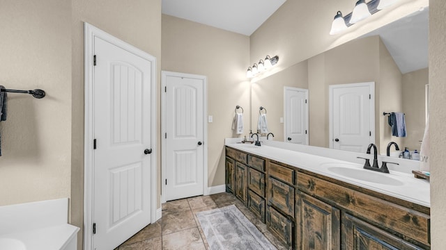 bathroom featuring double vanity, tile patterned flooring, and a sink