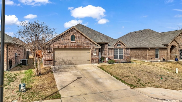 view of front of home featuring an attached garage, driveway, brick siding, and a shingled roof