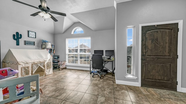 tiled home office with ceiling fan, baseboards, and vaulted ceiling