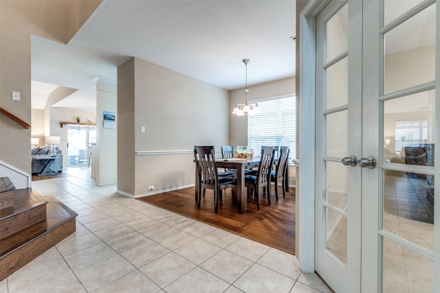 dining room featuring an inviting chandelier and light tile patterned floors