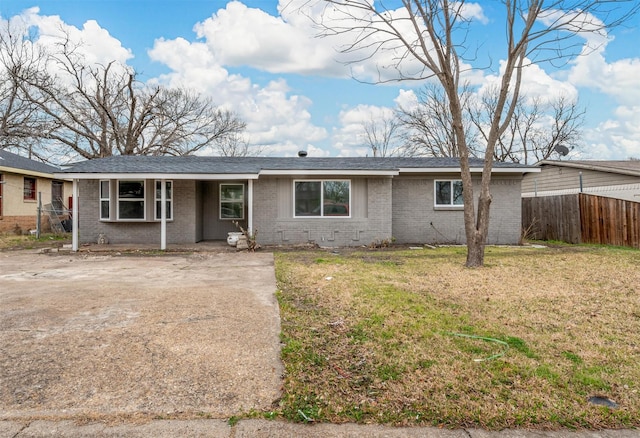 ranch-style home with a front lawn, fence, and brick siding