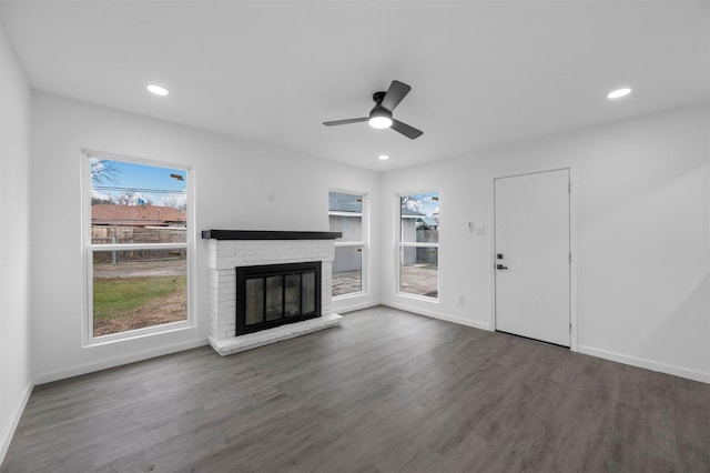 unfurnished living room featuring ceiling fan, recessed lighting, a fireplace, wood finished floors, and baseboards