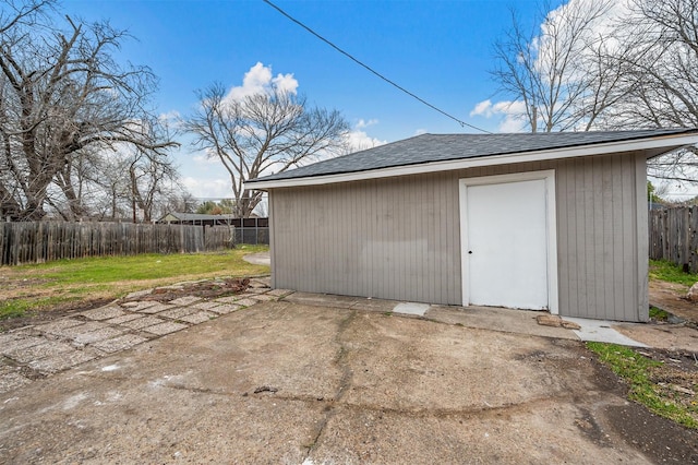 view of shed featuring fence