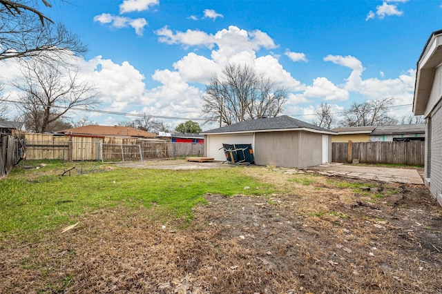 view of yard with a patio area, a fenced backyard, and an outdoor structure