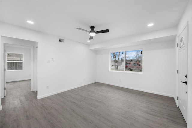 unfurnished room featuring ceiling fan, recessed lighting, wood finished floors, visible vents, and baseboards