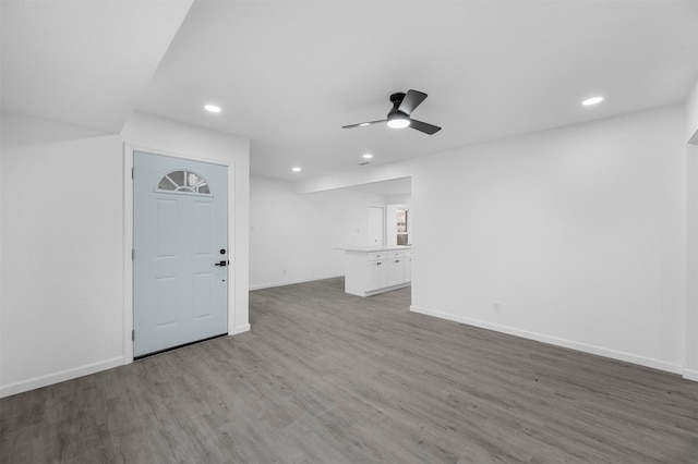 unfurnished living room featuring recessed lighting, wood finished floors, a ceiling fan, and baseboards