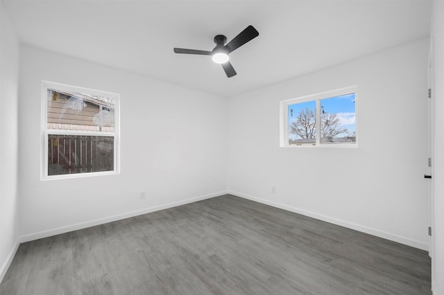 unfurnished room featuring ceiling fan, baseboards, and wood finished floors