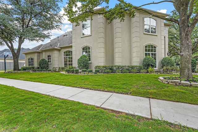 view of front of home with a front lawn and stucco siding