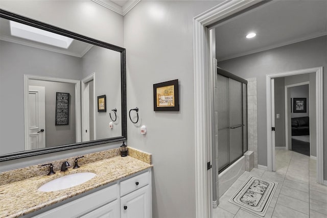 bathroom with ornamental molding, enclosed tub / shower combo, vanity, baseboards, and tile patterned floors