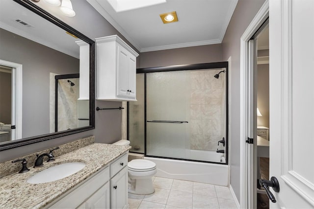 full bathroom featuring tile patterned flooring, vanity, visible vents, combined bath / shower with glass door, and ornamental molding